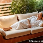Home 19 낮잠을 자는 이유와 그 효과 - A serene Mediterranean-style living room bathed in soft afternoon sunlight, featuring a middle-aged ...